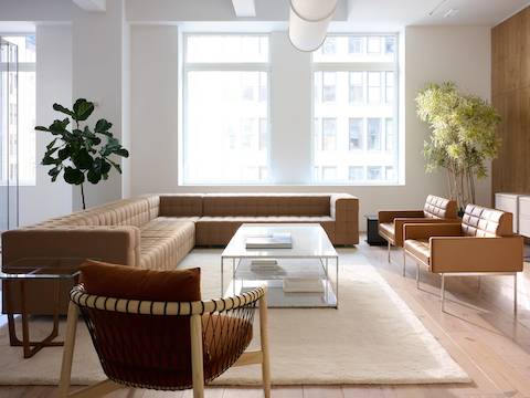 Lounge setting with a Rapport Sectional Sofa, Tuxedo Component Club Chairs, and Crosshatch Lounge Chair around two H-Frame Coffee Tables.
